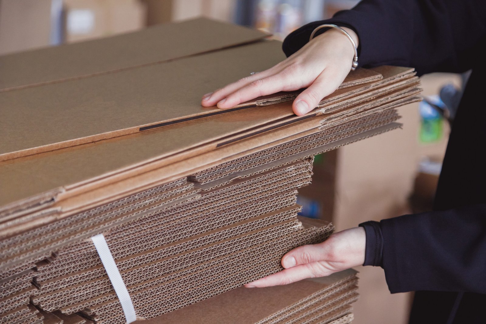 woman taking folded stacks of corrugated cardboard 2025 02 12 19 52 27 utc scaled
